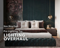 A modern bedroom with pendant lights hanging above both bedside tables