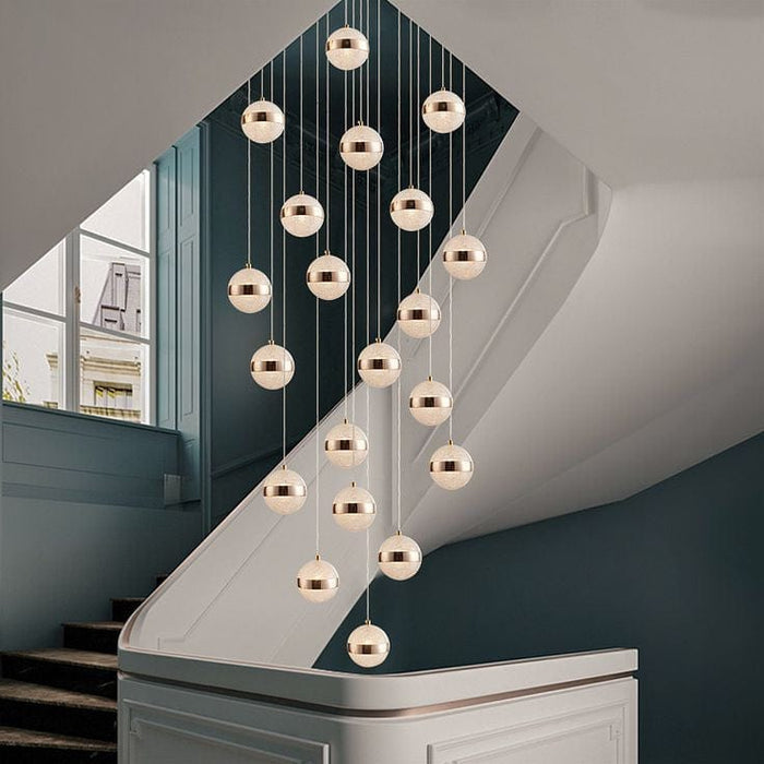 A staircase with a hanging chandelier