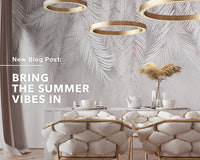 A modern dining room with gold and white chairs with title “Bring the Summer Vibes In”
