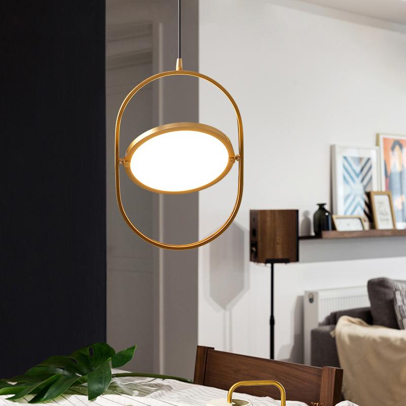 A modern gold pendant light with geometric features