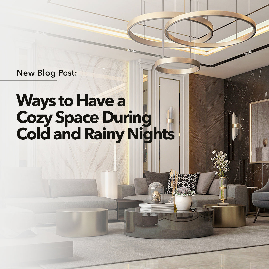 A gray living area with a gold chandelier hanging above