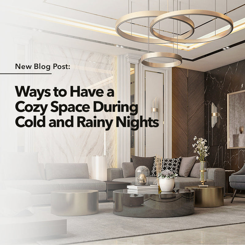 A gray living area with a gold chandelier hanging above