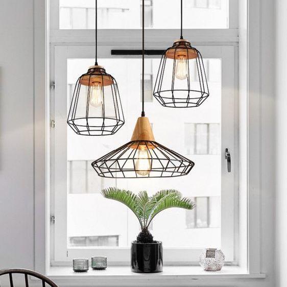 A white room with modern-style pendant lights built above.