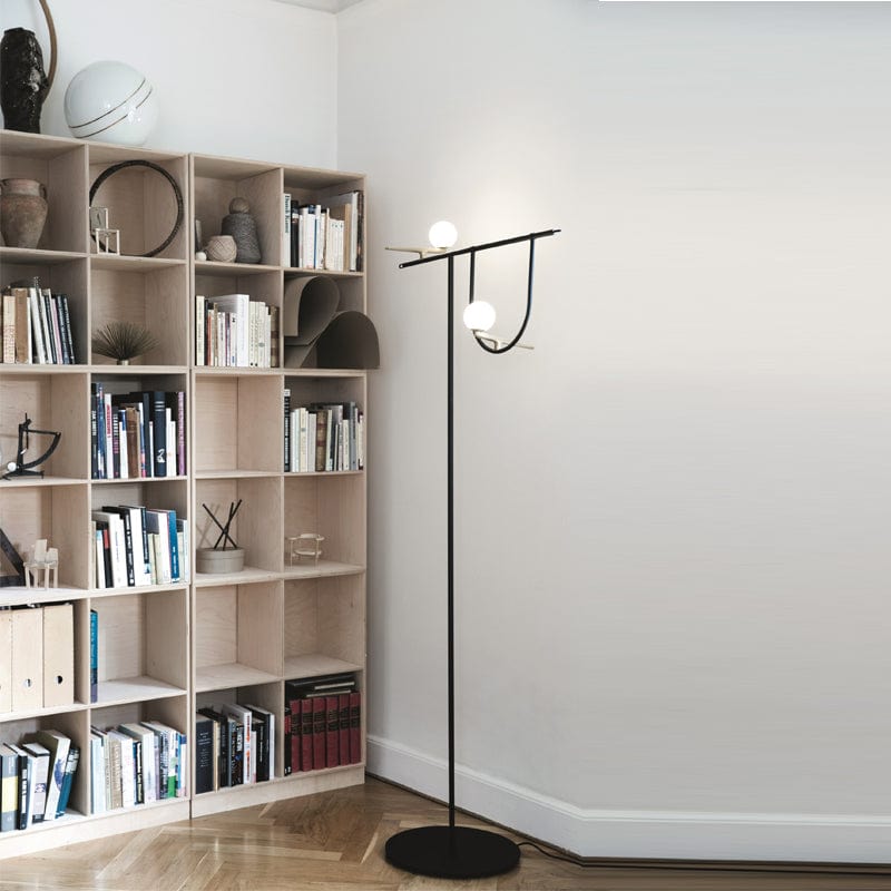 A minimalistic corner space with a solid black floor lamp
