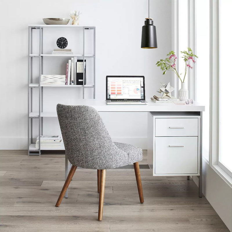 A home office with matching furniture and office lighting fixture above.
