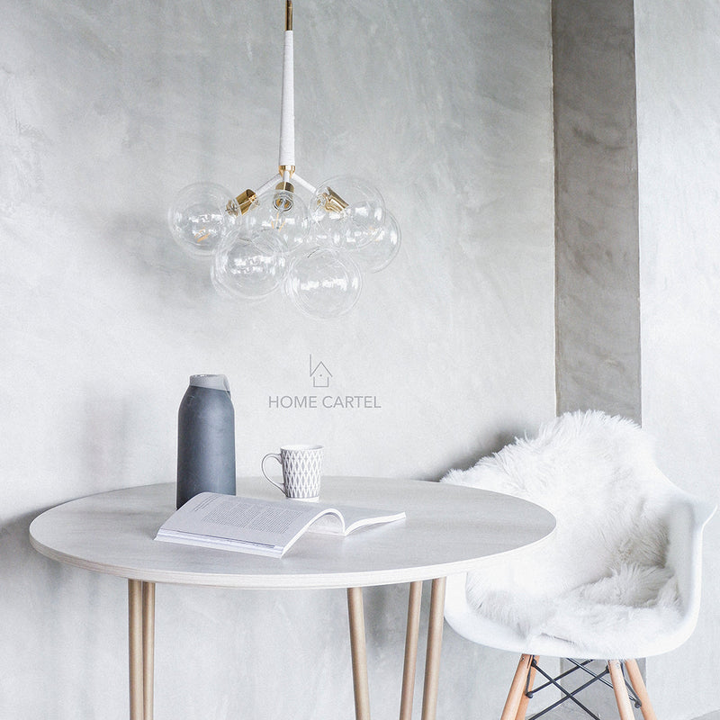 A white room with decorations and circular house lighting.